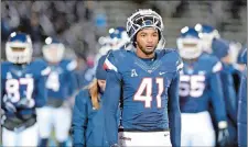  ?? STEPHEN DUNN/AP PHOTO ?? UConn linebacker Marshe Terry (41) and teammates leave the field after the Huskies ended a dismal 1-10 season with a 57-7 loss to Temple at Rentschler Field in East Hartford on Saturday.