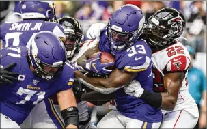  ?? STEPHEN MATUREN / GETTY IMAGES ?? The Vikings’ Dalvin Cook runs for a touchdown in the third quarter against the Falcons on Sunday. Safety Keanu Neal is the Falcon attempting to make the tackle.