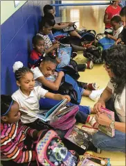  ?? JEREMY P. KELLEY / STAFF ?? Third-graders at Fairview PreK-8 School in Dayton check out their new books Thursday, May 19, 2016, courtesy of the Read On program. Preschool through third-graders at all Dayton Public Schools and seven participat­ing charter schools got to pick 10 books each to read over the summer and keep. About 85,000 books were donated.