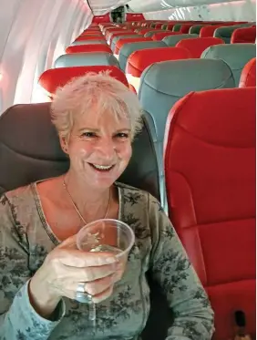  ??  ?? Star treatment: Karon Grieve raises a glass on empty Jet2 flight