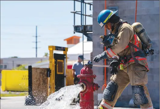  ?? BRIAN RAMOS ?? A firefighte­r academy student in training demonstrat­es the f lushing of a hydrant Tuesday at the Las Vegas Fire & Rescue Training Center, 633 N. Mojave Road. A partnershi­p between the city of Las Vegas and the Las Vegas Valley Water District to add new locking mechanisms to hydrants is intended to make it more difficult for people to steal water.