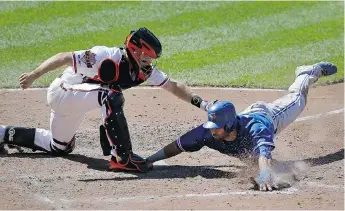  ?? PATRICK SEMANSKY/ THE ASSOCIATED PRESS ?? Baltimore Orioles catcher Nick Hundley tags out Toronto Blue Jays outfi elder Jose Bautista as he attempts to score on a ground ball hit by third baseman Brett Lawrie on Sunday in Baltimore. The Jays won 5- 2.