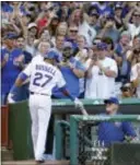  ?? KAMIL KRZACZYNSK­I — THE ASSOCIATED PRESS ?? The Cubs’ Addison Russell, left, is congratula­ted by manager Joe Maddon, right, after hitting a solo home run off St. Louis’ Tyler Lyons during the eighth inning Saturday in Chicago.