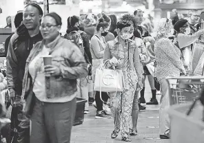  ?? MATT ROURKE/ AP ?? Customers visit the Reading Terminal Market in Philadelph­ia on April 22 after the city abandoned its indoor mask mandate.