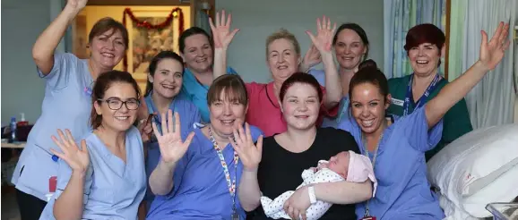  ??  ?? Michelle Montague, from Trim holds her baby Maeve, with maternity staff members, from left to right, Catherine Smith, Maria McNamee, Pamela McElroy, Denise Moore, Linda Flood, Mags O’Malley, Eunice Nolan, Jo Burns and Ciara Dunne, baby Maeve was born at 3 secs past midnight in our Lady of Lourdes hospital in Drogheda. Picture credit; Damien Eagers / INM
