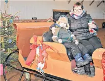  ?? DESIREE ANSTEY/JOURNAL PIONEER ?? Ozias Edmond, left, and his “Mimi”, Loretta Bertrand make the most of the fun activities, such as the sleigh, offered at the first-ever ‘Christmas on the Farm’ event held at the Venture Stables in Freetown.