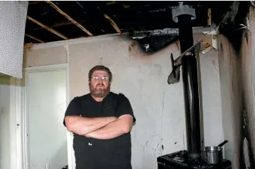  ?? PHOTO: CATHERINE GROENESTEI­N/STUFF ?? Peter Chandler, Kaponga, in his family’s burned out lounge.