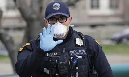  ??  ?? A Salt Lake City policeman works a scene. Photograph: Rick Bowmer/AP