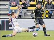  ?? KYLE ROBERTSON/THE COLUMBUS DISPATCH ?? Orlando City’s Will Johnson battles with Columbus’ Artur for the ball during the Lions’ loss Saturday to the Crew.