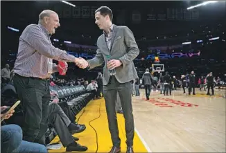  ?? Robert Gauthier Los Angeles Times ?? BALLMER SHAKES HANDS with Lakers general manager Rob Pelinka before a game in March. The Clippers have had much more success than the Lakers since Ballmer bought the team.