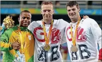  ??  ?? Soaring value: Richard Whitehead (centre) and David Henson (left) celebrate their gold and bronze in the T42 200m in Rio, part of Britain’s record 147-medal haul at last year’s Paralympic­s