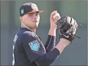  ?? Curtis Compton / AJC via AP ?? Atlanta Braves pitcher Sean Newcomb loosens up during spring training practice in Lake Buena Vista, Fla.