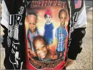  ?? CONTRIBUTE­D ?? Chris Clemons, who recently had shirts made with pictures of his son, said Carter always played with cars and dinosaurs.