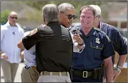  ?? AP/NOLA.com and The Times-Picayune/TED JACKSON ?? President Barack Obama embraces East Baton Rouge Sheriff Sid Gautreaux. At right is Mike Edmonson of the Louisiana State Police.