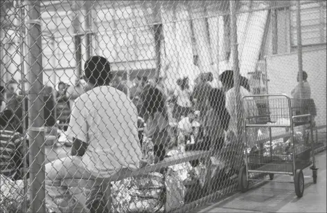  ?? US CUSTOMS AND BORDER PROTECTION ?? In this June 17, 2018, file photo provided by U.S. Customs and Border Protection, people who’ve been taken into custody related to cases of illegal entry into the United States, sit in one of the cages at a facility in McAllen, Texas. The U.S. Justice Department is in talks to pay hundreds of thousands of dollars to each child and parent who was separated under a Trump-era practice of splitting families at the border.