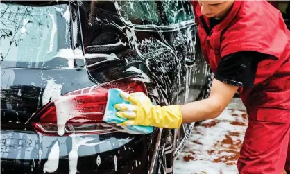  ??  ?? While many hand carwashes are legitimate businesses, some do not provide employees the essential protective clothing pictured. Photograph: Getty/iStockphot­o