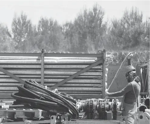  ?? GIULIO NAPOLITANO / BLOOMBERG ?? An employee works at the Trans Adriatic Pipeline receiving terminal constructi­on site in Melendugno, Italy. In northern Italy, protesters have managed to halt the high-speed rail line between Italy and France for well over a decade.