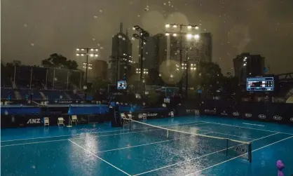  ??  ?? Heavy, and much welcome, rain falls at Melbourne Park ahead of the Australian Open. Photograph: Scott Barbour/EPA