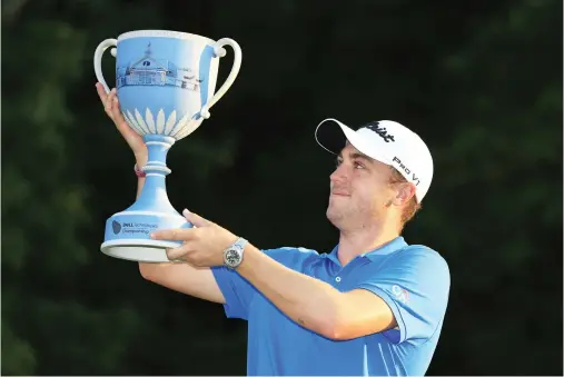  ??  ?? Justin Thomas of the US with the trophy after winning the Dell Technologi­es Championsh­ip at TPC Boston on Monday in Norton, Massachuse­tts. (AFP)