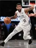  ?? Dustin Satloff / Getty Images ?? Kyrie Irving scored 21 of his 32 points in the final 9 1⁄2 minutes to lift the Nets to their 9th straight win over the Knicks.