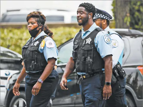  ?? JOSE M. OSORIO/CHICAGO TRIBUNE ?? Police officers stand outside the Cook County medical examiner’s office on July 28 after a procession for Deputy Chief Dion Boyd.