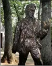  ?? AP/MICHAEL DWYER ?? A statue of Henry David Thoreau stands outside a replica of his cabin near the shores of Walden Pond in Concord, Mass.