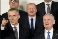  ?? VIRGINIA MAYO — THE ASSOCIATED PRESS ?? NATO Secretary General Jens Stoltenber­g, front left, and U.S. Secretary of Defense Jim Mattis, front right, stand with other NATO defense ministers during a group photo at NATO headquarte­rs in Brussels on Wednesday.