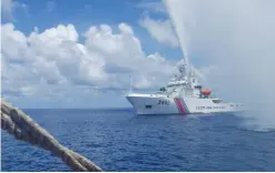  ??  ?? In this Sept 23, 2015, file photo, Chinese Coast Guard members approach Filipino fishermen as they confront each other off Scarboroug­h Shoal in the South China Sea, also called the West Philippine Sea. — AP