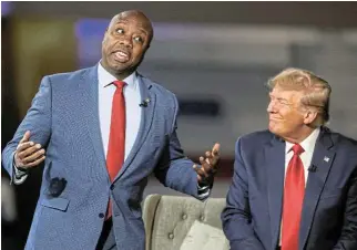  ?? /Reuters ?? Lost in thought: US Senator Tim Scott and former US president and Republican presidenti­al candidate Donald Trump participat­e in a Fox News town hall meeting in Greenville, South Carolina, US, on Tuesday..