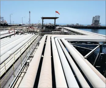  ??  ?? An oil tanker being loaded at Saudi Aramco’s Ras Tanura oil refinery and oil terminal in Saudi Arabia. As supply losses in Opec pile up, its biggest producer, Saudi Arabia, is trying to plug the gap.