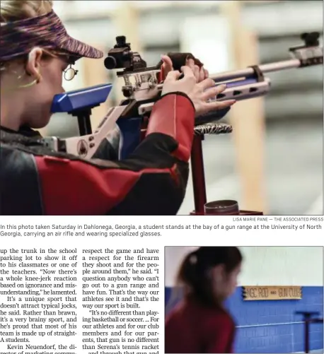  ?? LISA MARIE PANE — THE ASSOCIATED PRESS ?? In this photo taken Saturday in Dahlonega, Georgia, a student stands at the bay of a gun range at the University of North Georgia, carrying an air rifle and wearing specialize­d glasses.