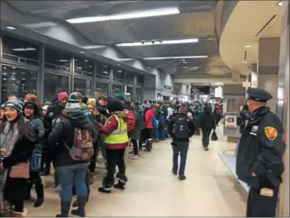  ?? PHOTOS BY L.A. PARKER - THE TRENTONIAN ?? Trenton Transporta­tion Center packed with Eagles fans as SEPTA ran three early-morning trains to Philadelph­ia for the Eagles Championsh­ip parade.