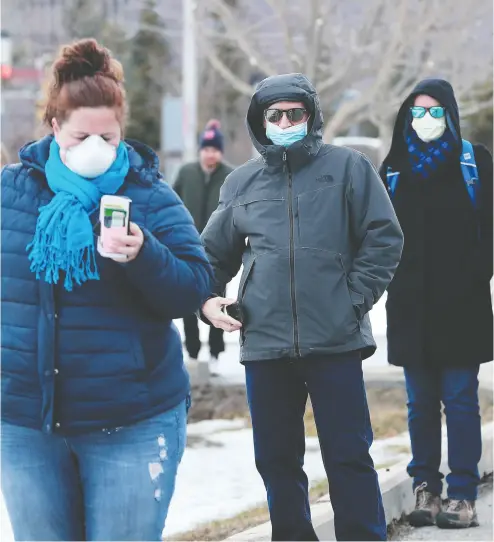  ?? Julie Oliver / Postmedia news ?? People were lined up around the block to get tested at Ottawa’s first COVID-19 Assessment Centre at Brewer Arena on Friday. By 2 p.m., there were almost 100 people lined up in the parking lot, all practising social distancing.