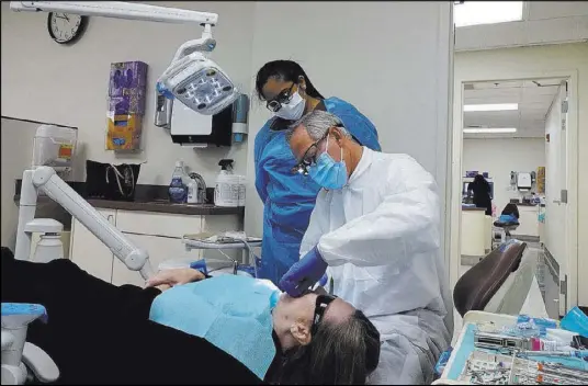  ?? Craig Ruark Las Vegas Business Press ?? Former UNLV dentist Phillip Devore, seen above working with a student, is in private practice in Las Vegas and said in an interview that he knew little about the school’s billing practices.