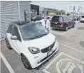  ?? BOB TYMCZYSZYN THE ST. CATHARINES STANDARD ?? Ryan Heikoop with his electric Smart car at the Performanc­e Mercedes dealership.