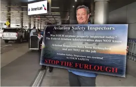  ?? PEDRO PORTAL pportal@miamiheral­d.com ?? Troy Tomey, an FAA safety inspector who has been furloughed, was among a group of inspectors picketing at MIA last Thursday.