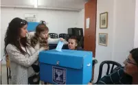  ?? (Marc Israel Sellem/The Jerusalem Post) ?? A CHILD casts her mother’s vote in the 2015 election.