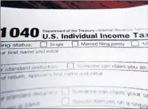  ?? KEITH SRAKOCIC/AP ?? A 1040 federal tax form, printed from the Internal Revenue Service website, in Zelienople, Pennsylvan­ia. Experts say people should be aware of certain situations, including working in a different state or claiming a stimulus payment, that could affect their tax liability.