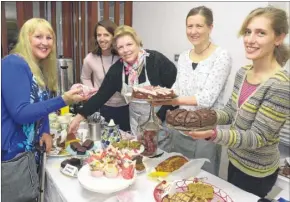  ?? Pictures: Chris Davey FM4544915 ?? Alicia Duke buys cake from Sarah Moir, Sharon Linthwaite, Jo Rickards and Katerine Rutherford at the Knorton Knatchbull School craft fair on Sunday