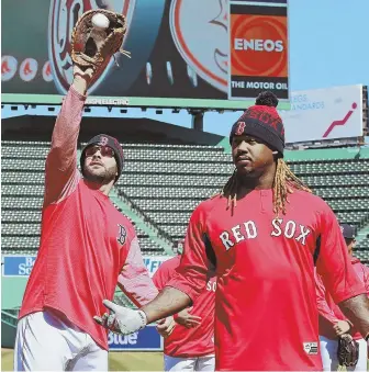  ?? STAFF PHOTO BY MATT WEST ?? TAKE A STAB: Hanley Ramirez doesn’t seem to know where the ball is as first baseman Mitch Moreland reaches up to grab it yesterday at Fenway.