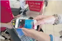  ?? LAURA PEDERSEN ?? Apple Pay has launched an expansion in Canada, another cashless way for Canadians to shop, allowing clients of seven major Canadian banks to use the service with Visa, MasterCard and Interac.