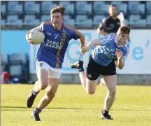  ??  ?? Gavin Fogarty keeps possession despite being pulled back by Darragh McLoughney in the Leinster Minor Football Championsh­ip in Parnell Park. Photo: Dave Barrett