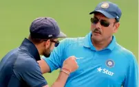  ?? AFP file ?? India’s Virat Kohli (left) interacts with Ravi Shastri, director for the Indian team during the South Africa series in 2015. —