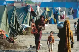  ?? FAREED KHAN/AP ?? Victims of heavy flooding from monsoon rains take refuge Saturday at a temporary tent camp set up by the U.N. refugee agency UNHCR in Sukkur, Pakistan.