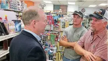  ?? [PHOTO BY CHRIS CASTEEL, THE OKLAHOMAN] ?? Mick Cornett, left, a Republican candidate for governor, speaks to farmer Scott Neufeld, right, and his son, Caleb, on Tuesday in Fairview.