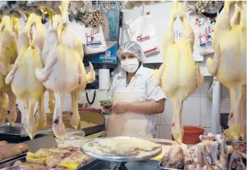  ?? MARTIN MEJIA/AP ?? Poultry vendor Irma Sanchez waits for customers in her stall Saturday at a central market in Lima, Peru. Inflation will continue to be a regional headache coupled with a lack of investment, according to a recent forecast offered by the Economic Commission for Latin America and the Caribbean.