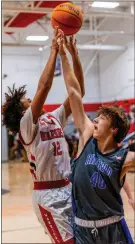  ?? Charlie Qualls, warriors In Motion Photograph­y ?? Ringgold’s Brody Raby tries to deflect a shot by Lakeview’s Caleb Underwood during a game at Lakeview last Tuesday. Raby and the Tigers won a close one to wrap up the NGAC West Division title.