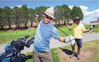  ?? ADOLPHE PIERRE-LOUIS/JOURNAL ?? City Hackers League members Tom Matthews, left and Andre Houle stretch before playing a round of nine holes at Arroyo del Oso Golf Course.