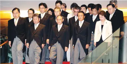  ??  ?? Newly-appointed Japanese Prime Minister Yoshihide Suga leads his cabinet members to a photo session at the prime minister’s official residence in Tokyo yesterday.