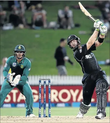  ?? PHOTO: MICHAEL BRADLEY ?? New Zealand batsman Martin Guptill thrashes the ball as South Africa's Quinton de Kock watches during their One-Day Internatio­nal in Hamilton yesterday.